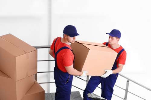 Moving team preparing a home relocation in Wandsworth with packed boxes