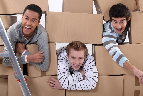 Team loading boxes and furniture into a moving van